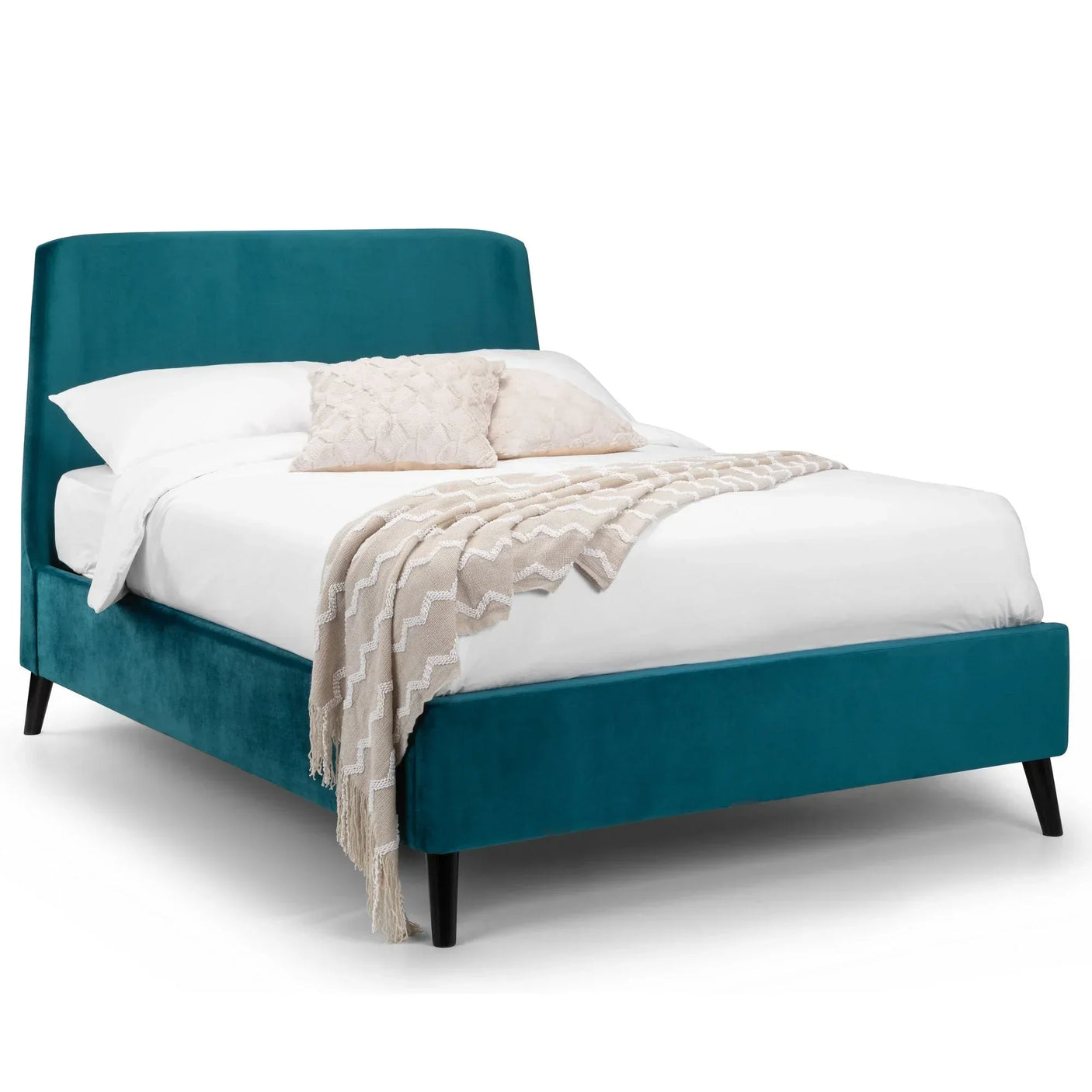 Teal velvet king size bed with angled headboard, black legs, cream throw and pillows
