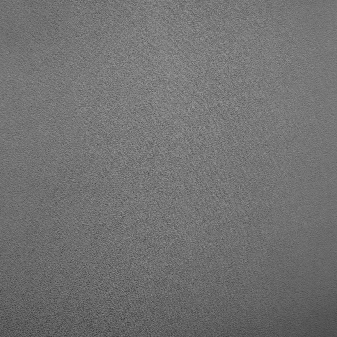 Grey velvet fabric texture detail from king bed upholstery