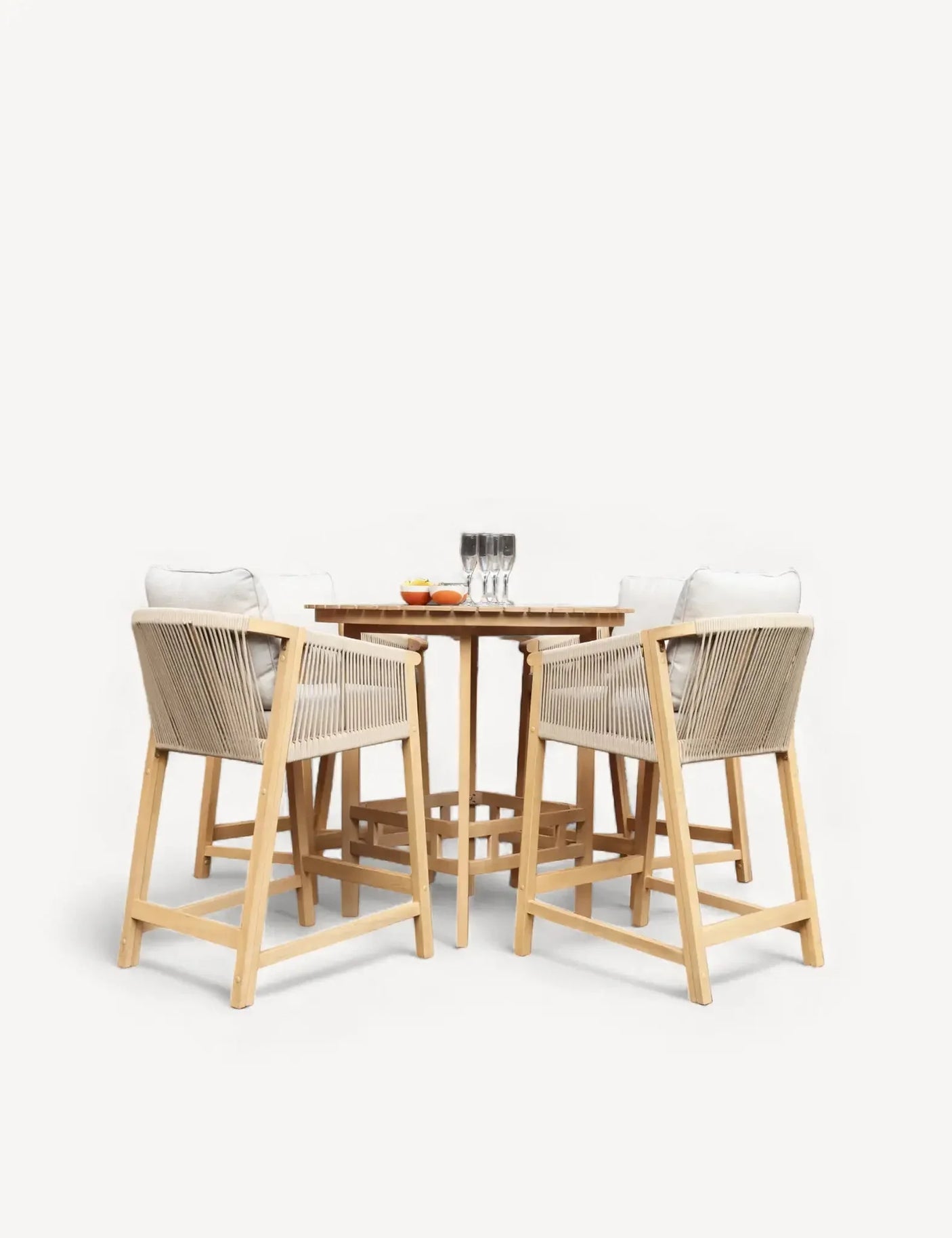 Wooden outdoor bar table with four rope weave chairs and seat cushions