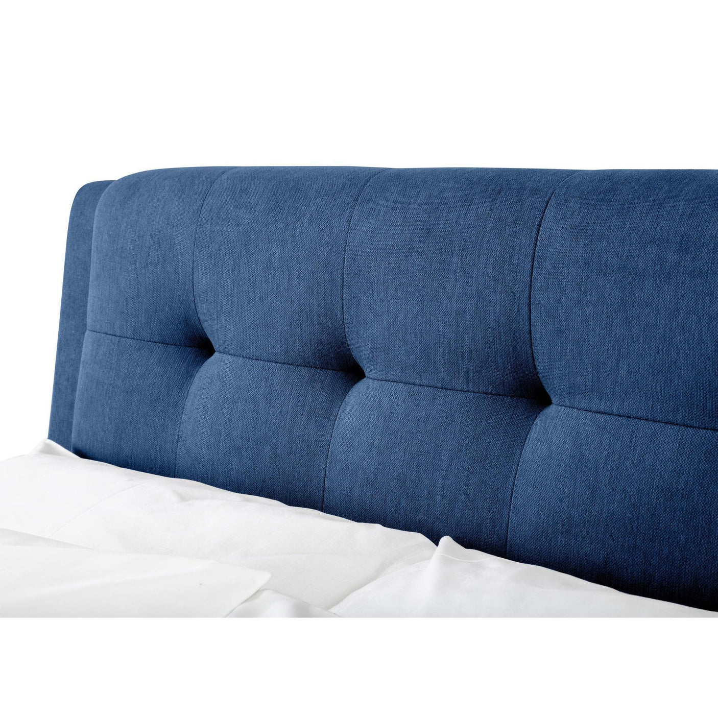 Blue fabric double bed headboard with square tufted detail and white bedding