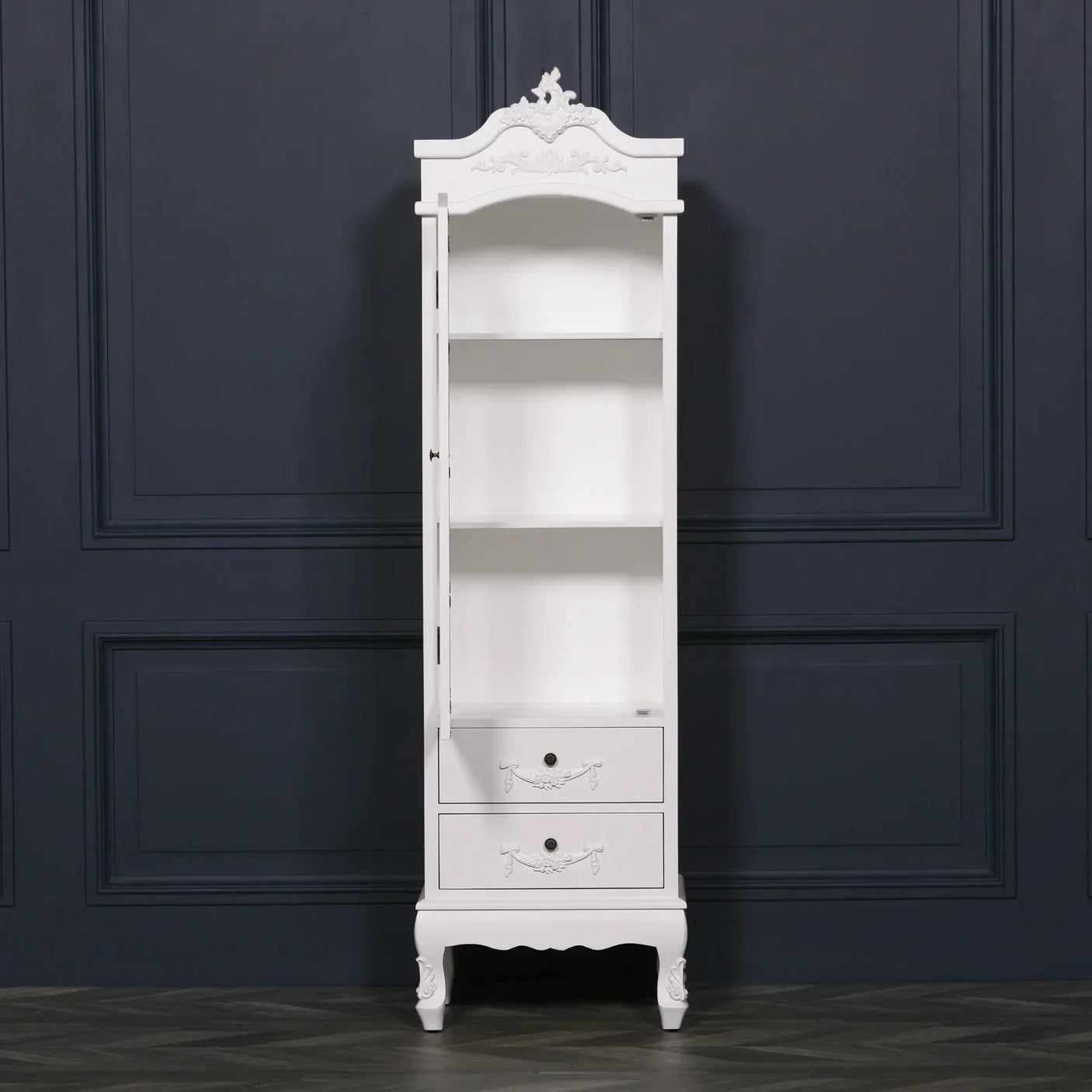 White tall display cabinet with glass door, three shelves and two drawers, ornate detailing