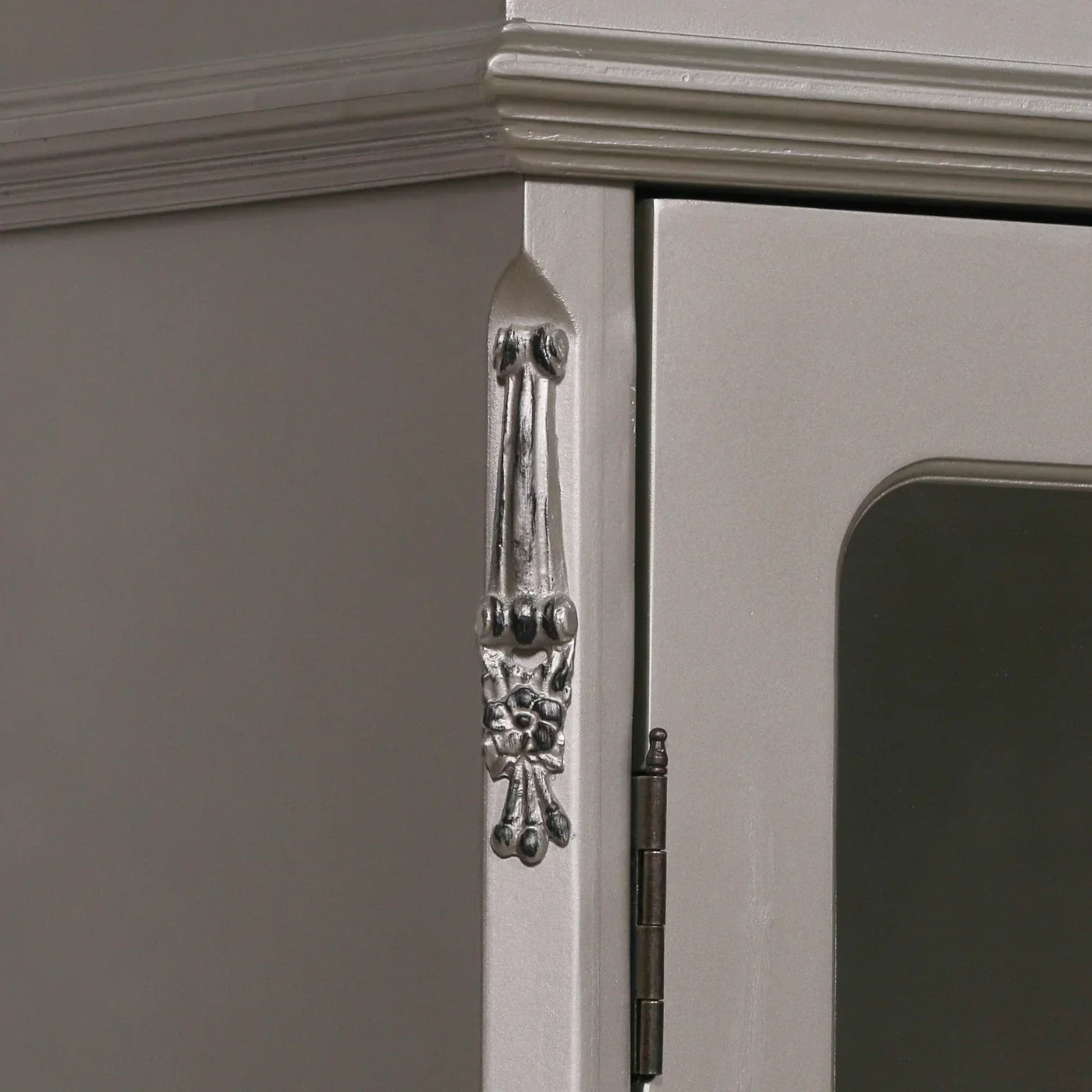 Silver wardrobe corner with decorative trim and door hinge detail