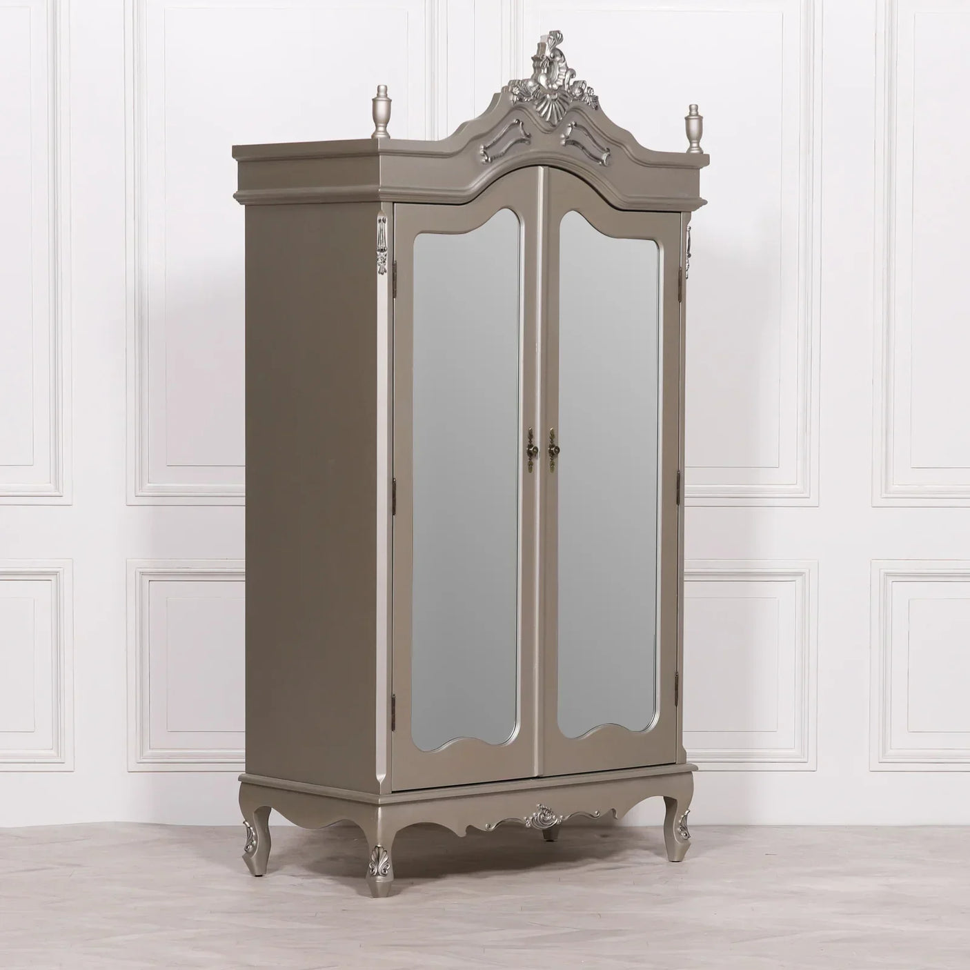 Mirrored grey wardrobe with ornate carved detailing and double doors against white wall