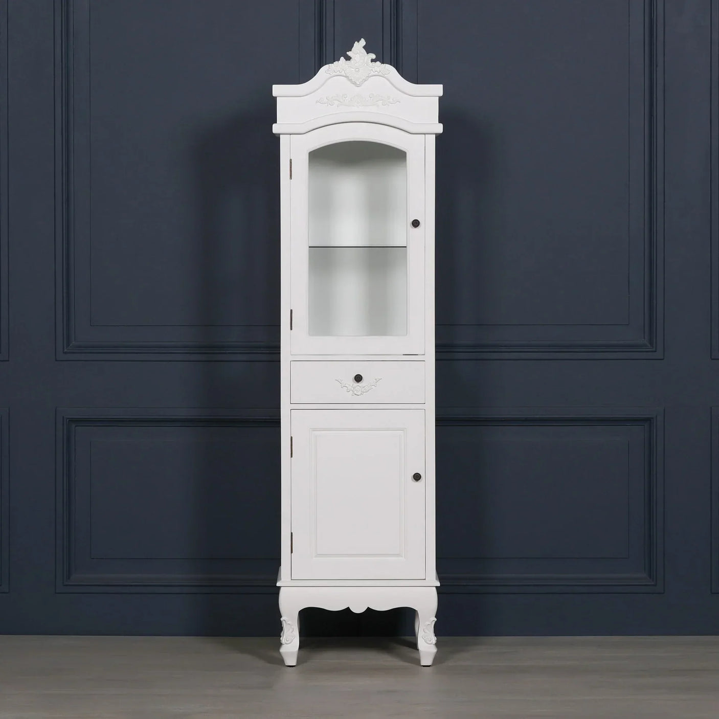 White wooden display cabinet with glass door, single drawer and ornate detailing