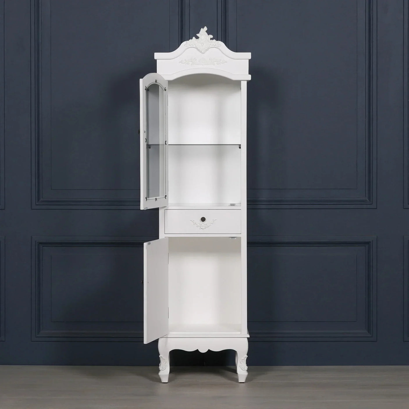 White tall display cabinet with glass door, shelf, drawer and open lower cupboard