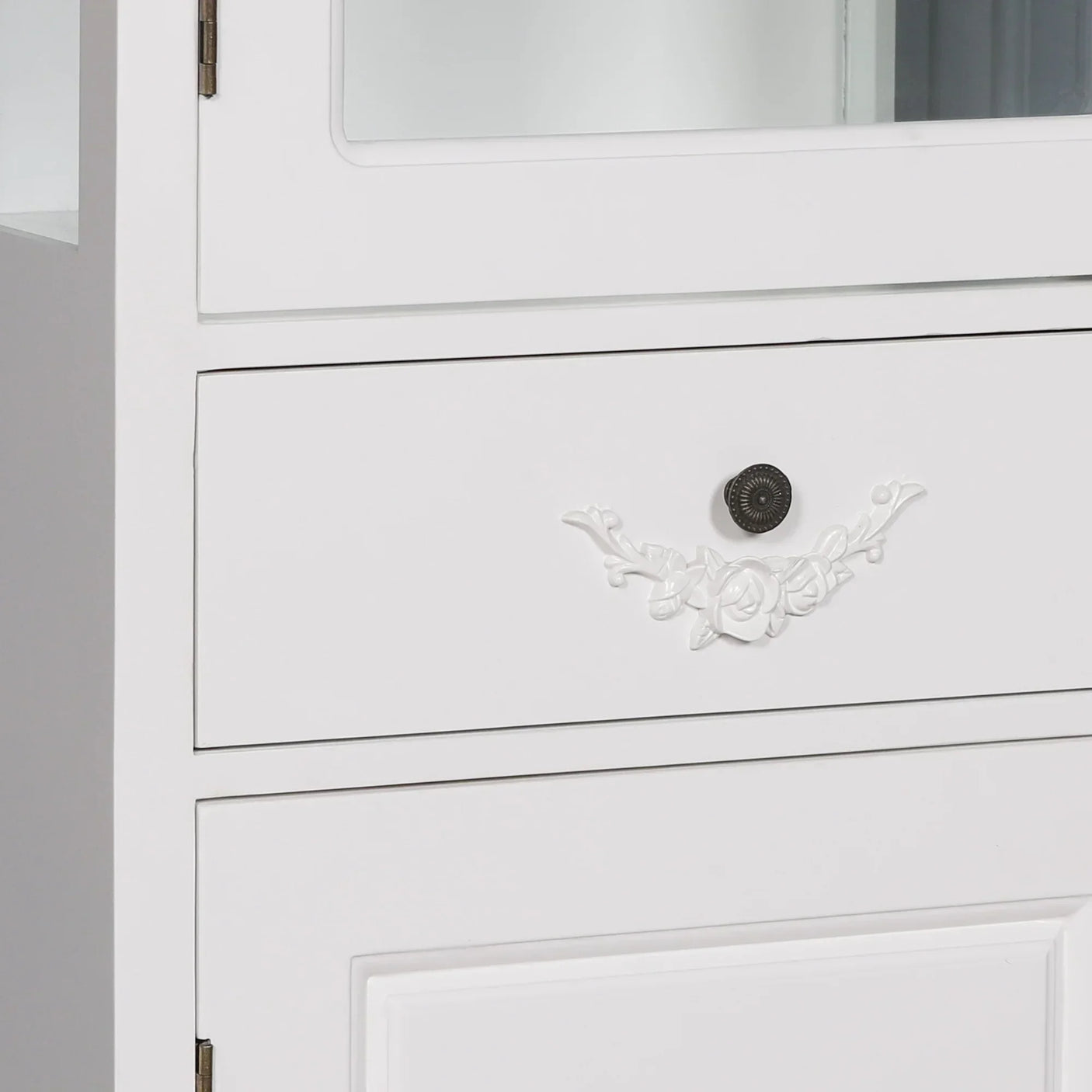 White wooden cabinet drawer with floral handle and decorative knob detail