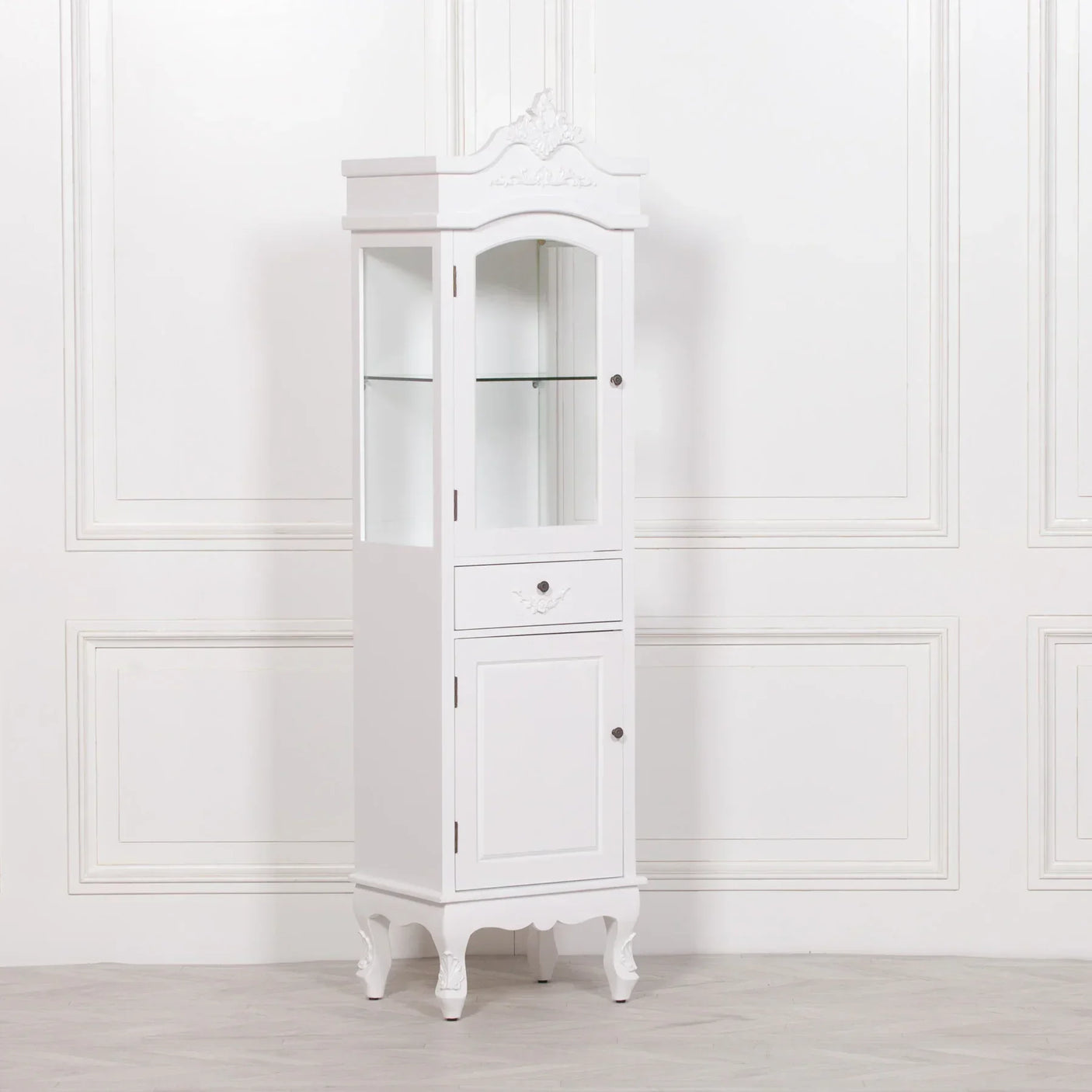 White display cabinet with glass shelf, single drawer, and decorative carved detail