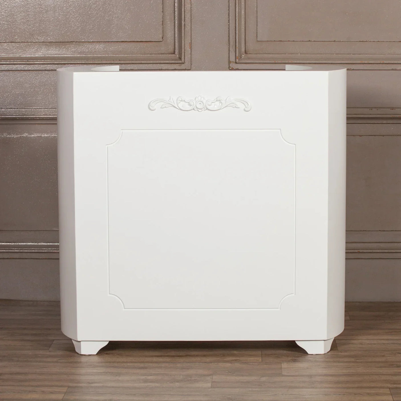 White radiator cover with decorative panel and subtle carved trim on wooden floor