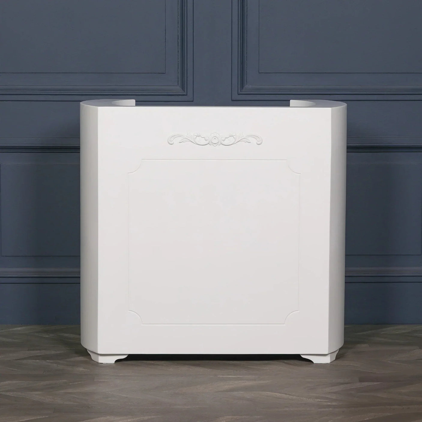 White radiator cover with decorative panel and curved edges against blue wall