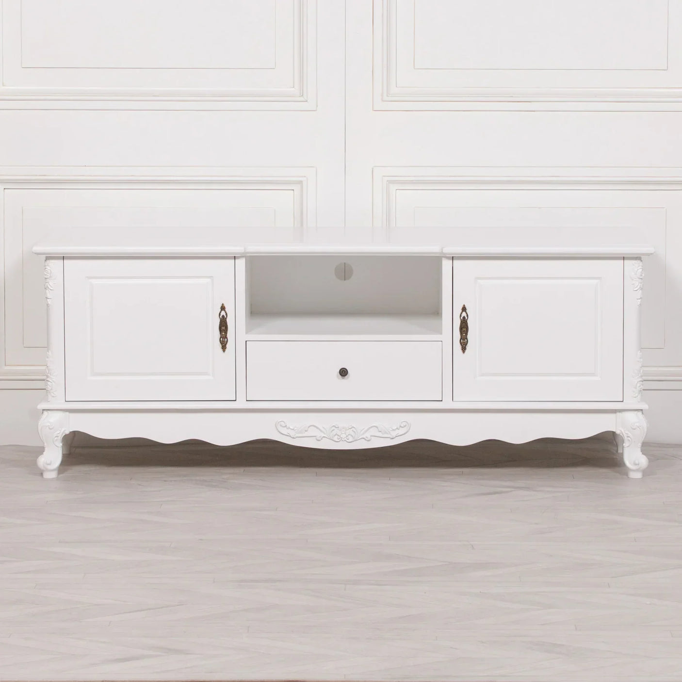 White TV unit with two cabinets, central open shelf, and decorative carved legs