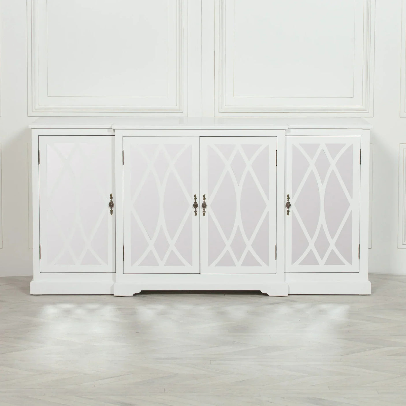 White sideboard cabinet with geometric pattern doors and antique metal handles in modern room