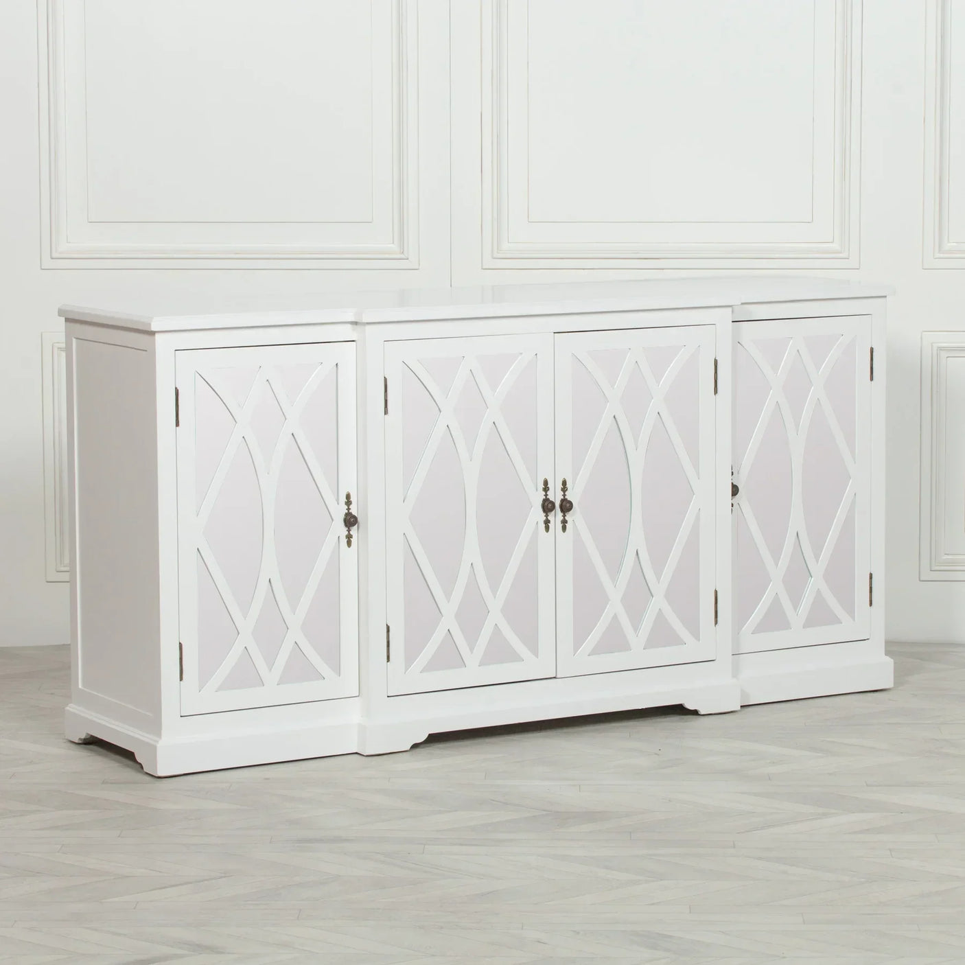White sideboard cabinet with geometric door panels and metal handles in a modern room