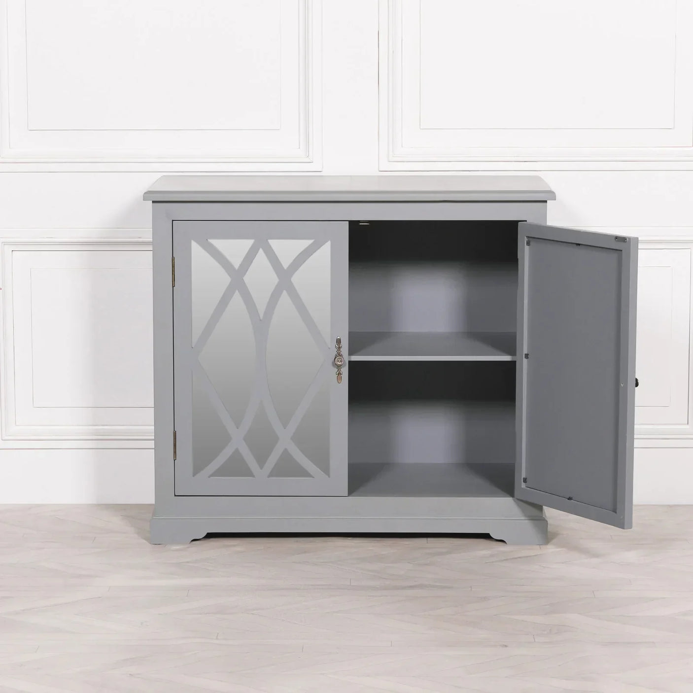 Grey sideboard cabinet with mirrored door and interior shelf, one door open, against wall
