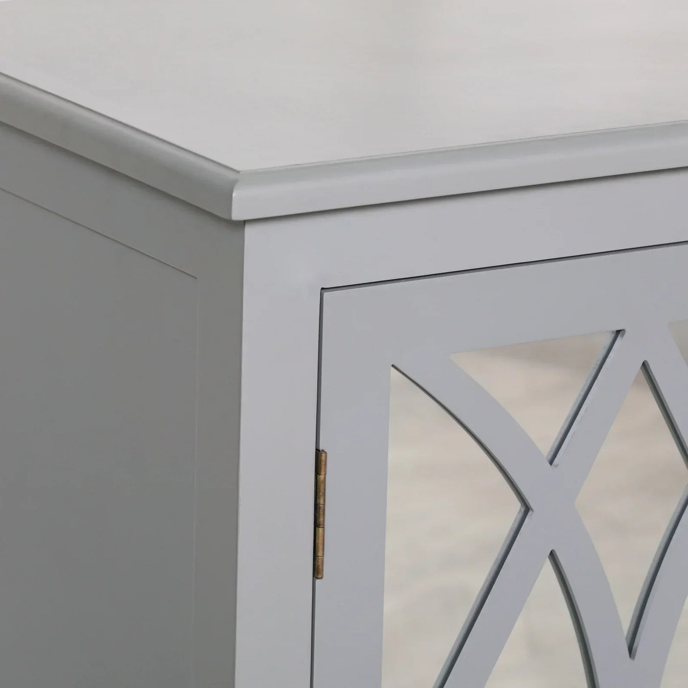Close-up of grey wooden cabinet with mirrored door and geometric lattice design