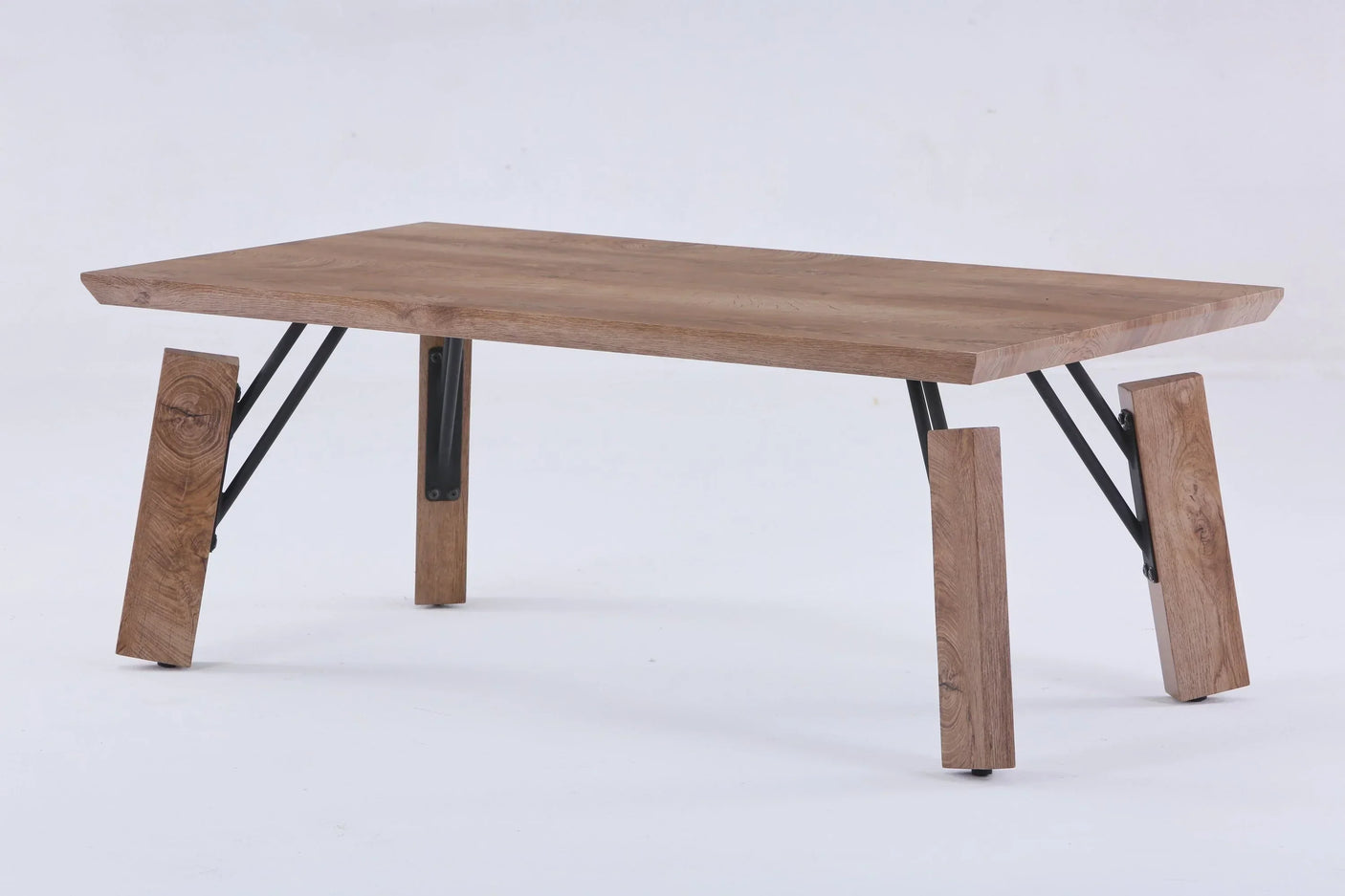 Rectangular wooden coffee table with splayed legs and black metal supports on white background