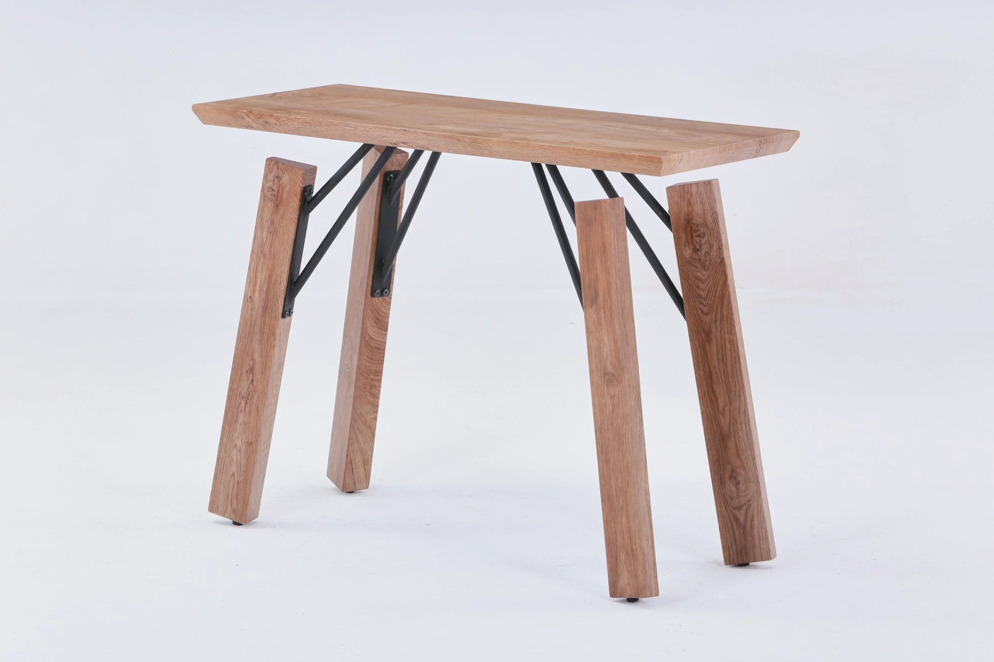 Wood console table with angled legs and black metal supports on white background