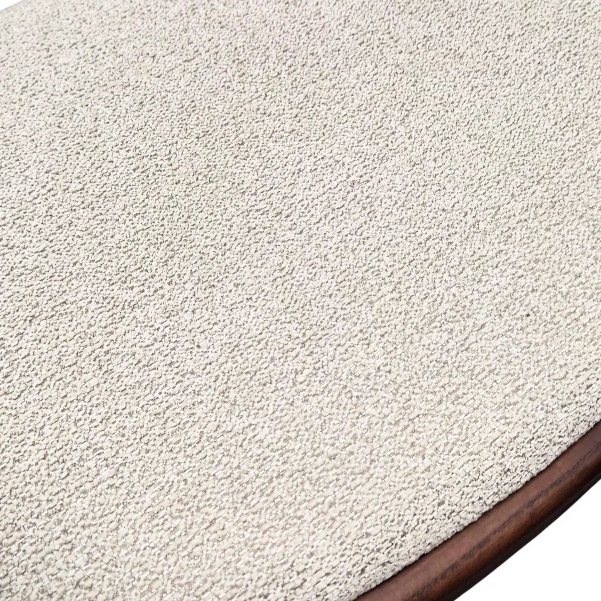 Closeup of cream textured fabric seat with wooden edge on accent chair