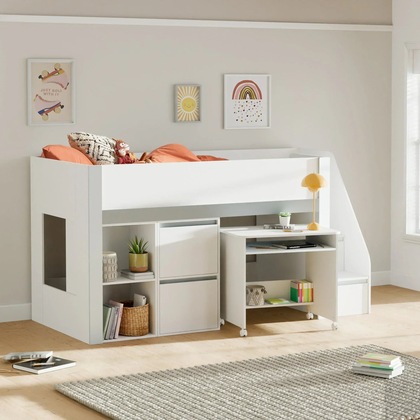 White kids cabin bed with built-in storage, pull-out desk, and orange bedding in modern room