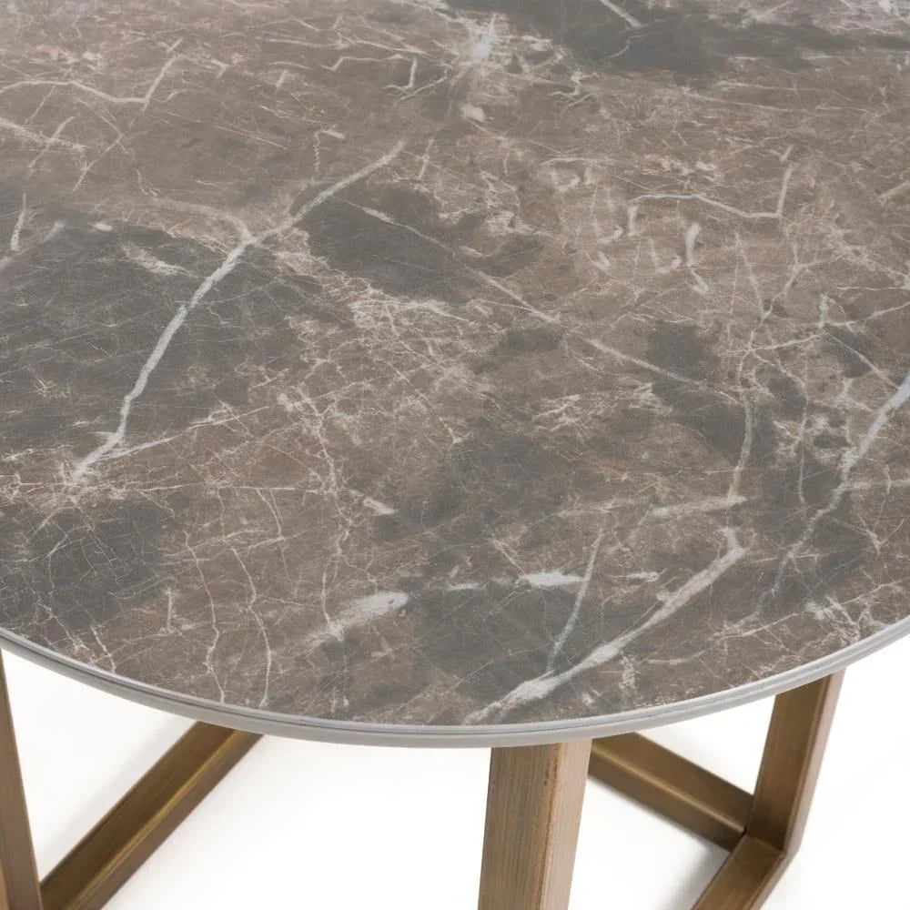 Round marble effect dining table with brown veining and metal legs, close view