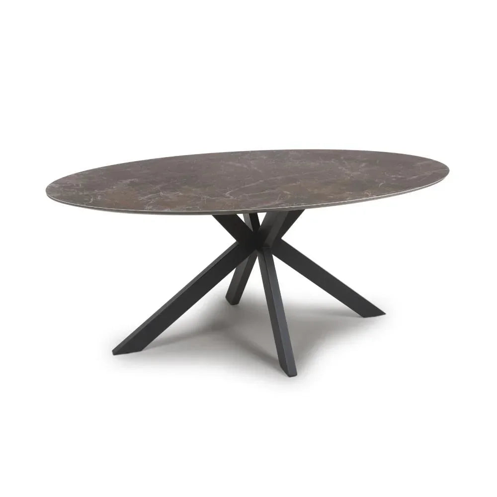 Oval dining table with dark marble top and black angled metal legs