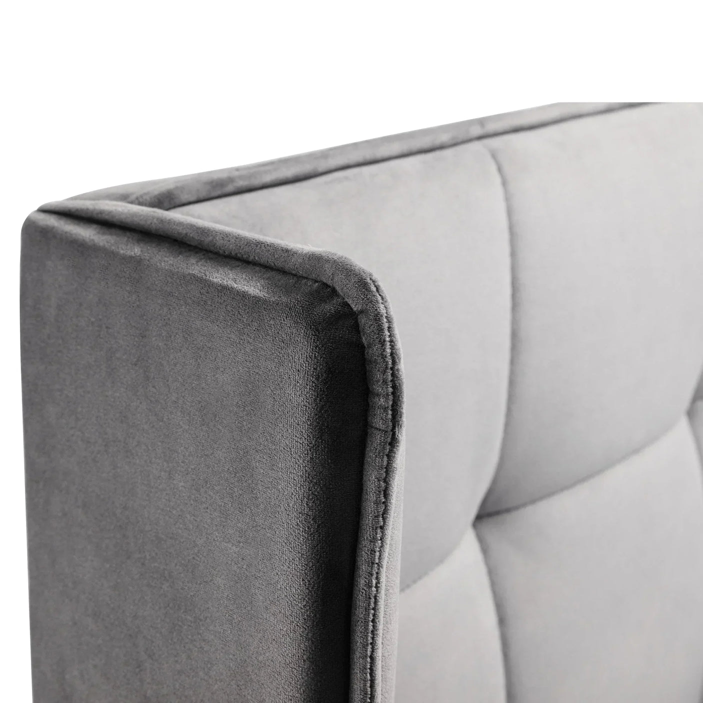 Grey upholstered bed headboard with soft fabric and square stitched panel detail