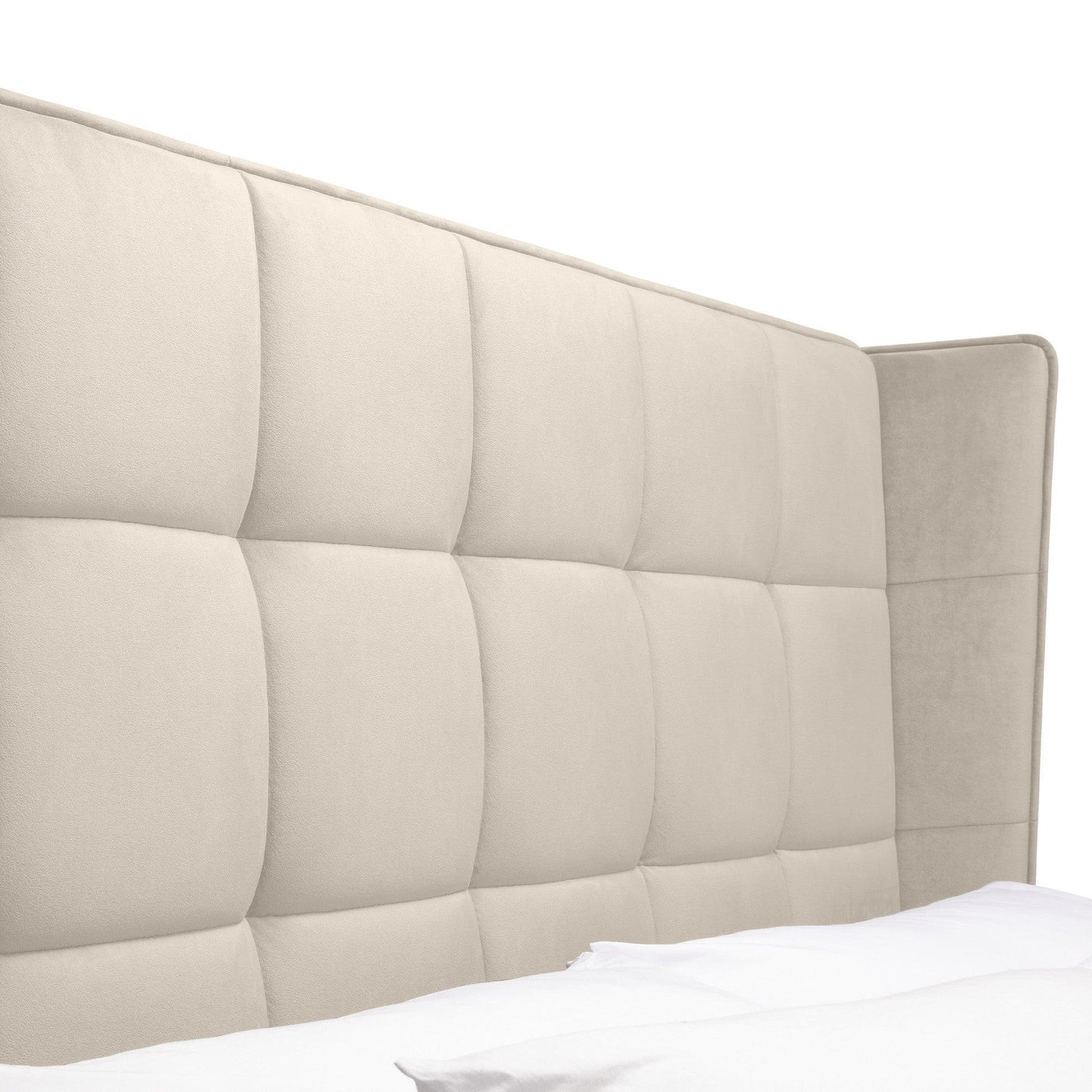 Beige upholstered bed headboard with grid tufted panels, side angle view