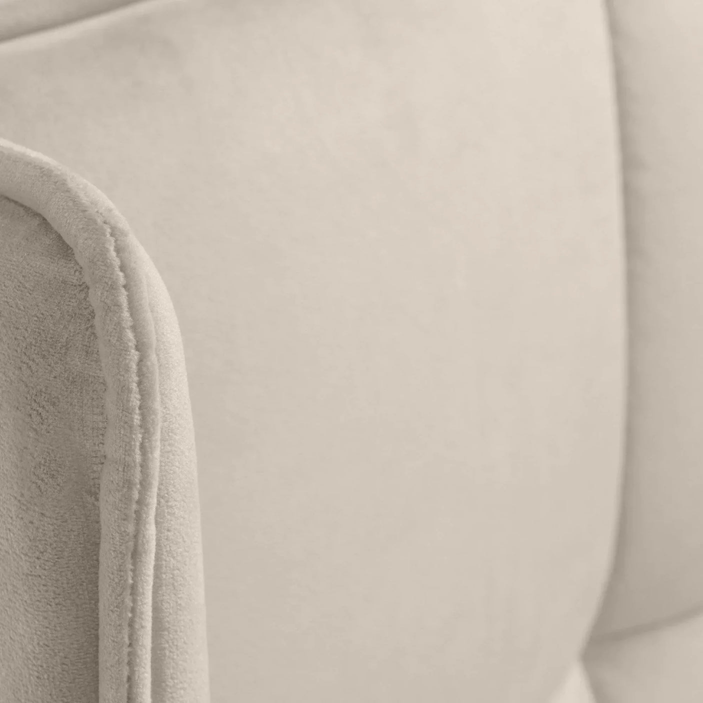Closeup of beige fabric sofa cushion with soft textured upholstery detail