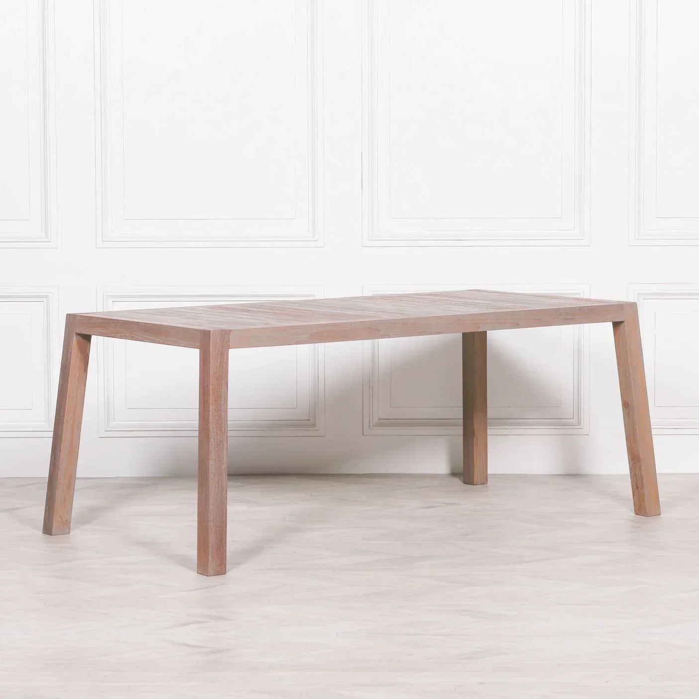 Rectangular wooden dining table with angled legs and natural finish in bright room