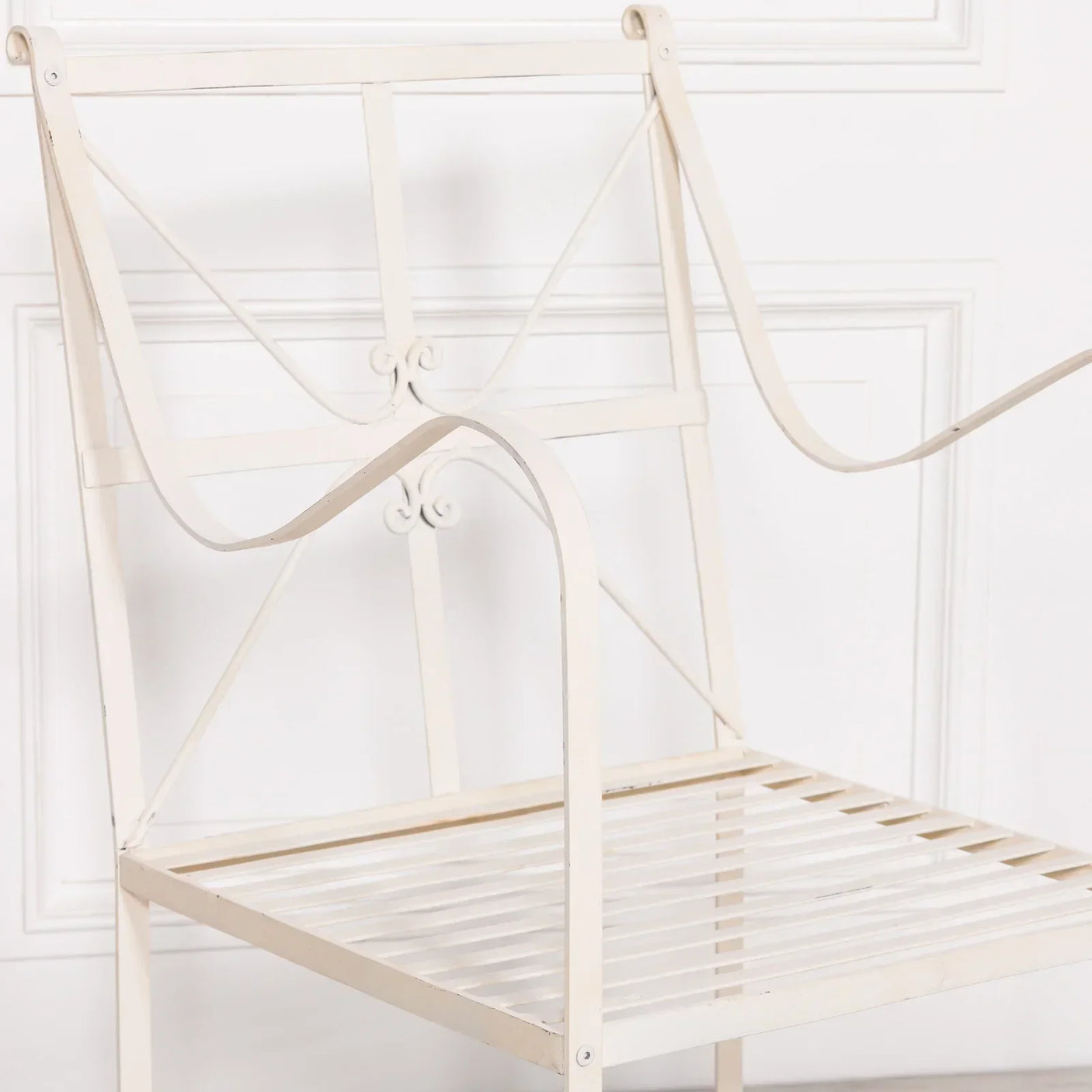 Cream metal garden chair frame with slatted seat and decorative backrest detail