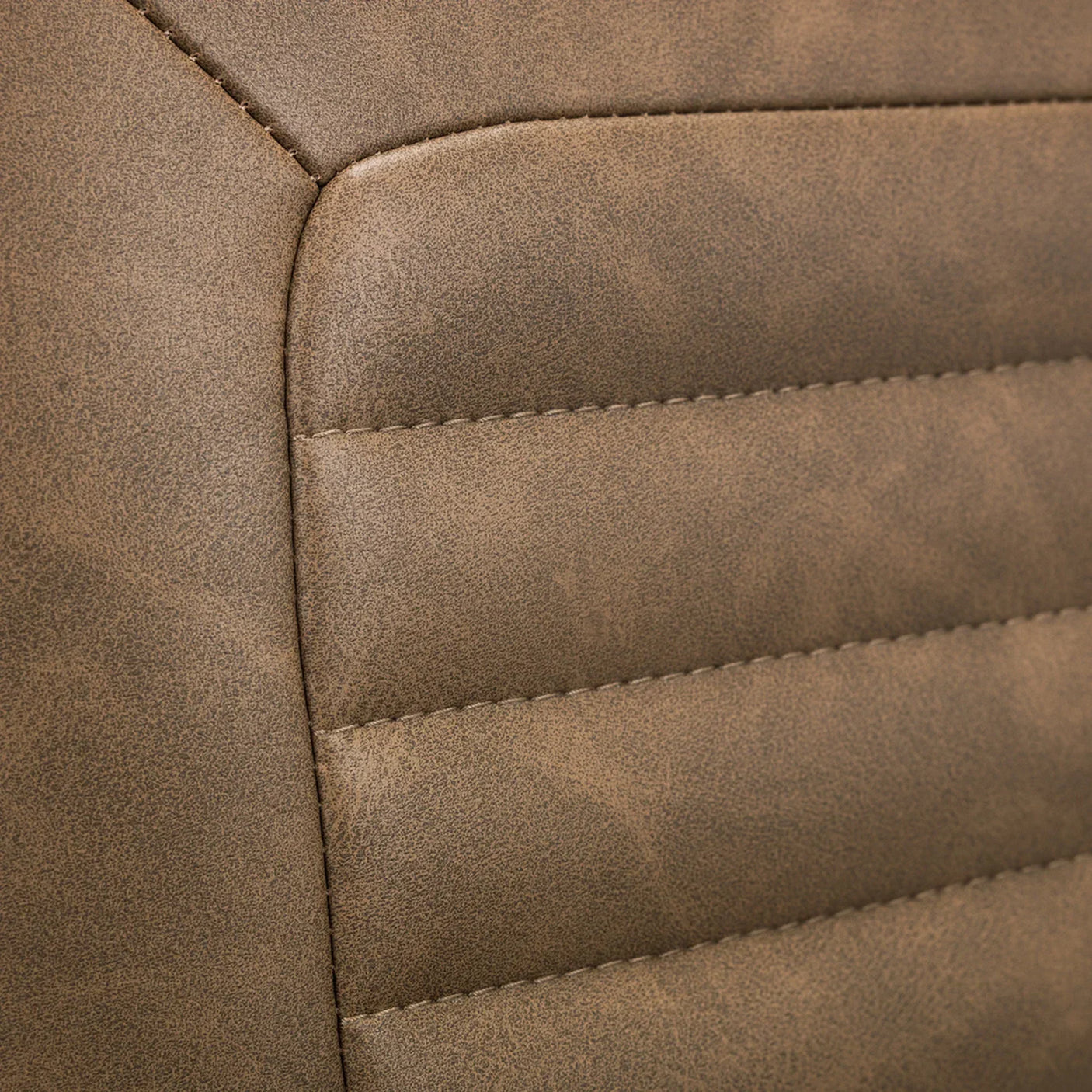 Detail of brown faux leather swivel chair upholstery with stitched panels