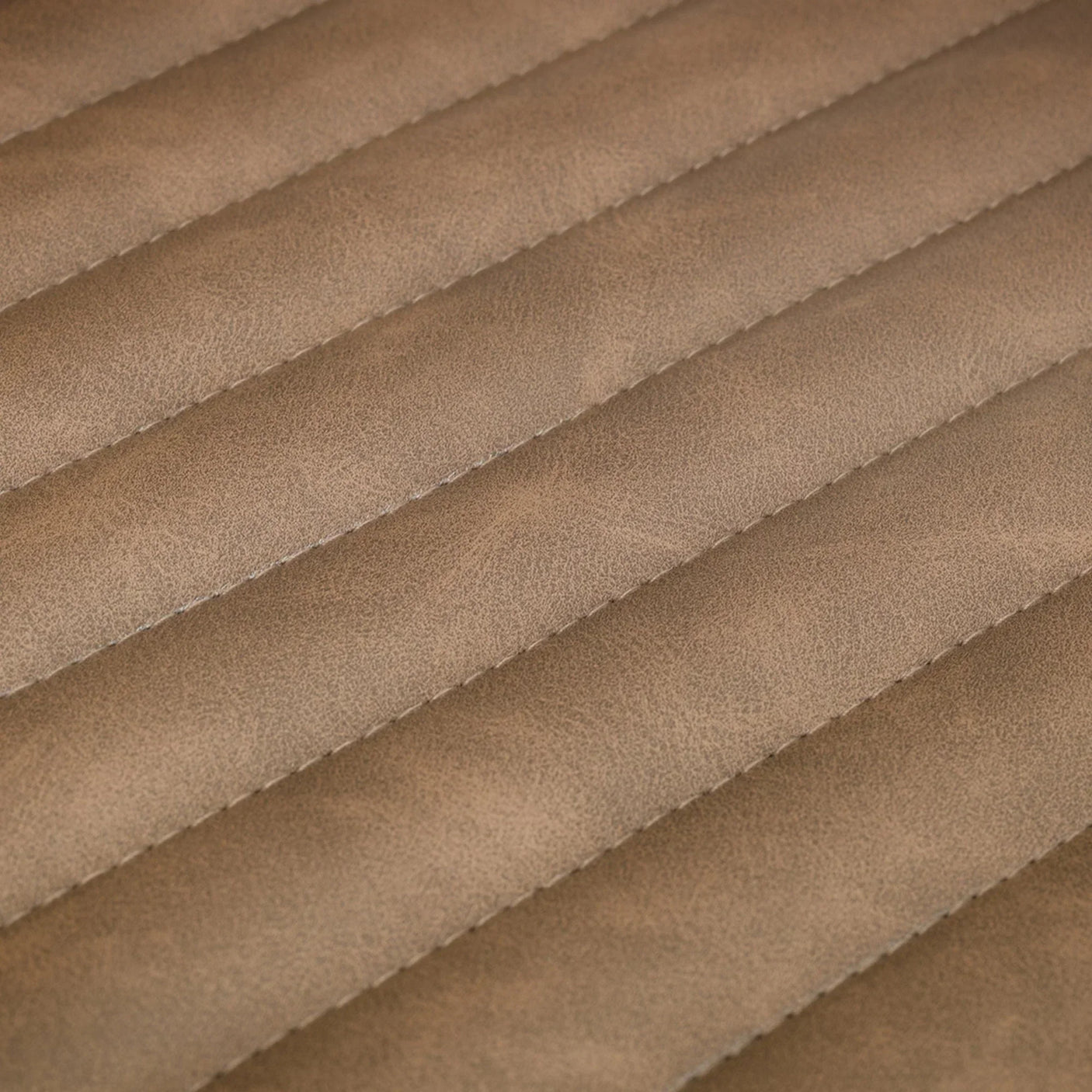 Close up of brown faux leather swivel chair upholstery with horizontal stitched panels