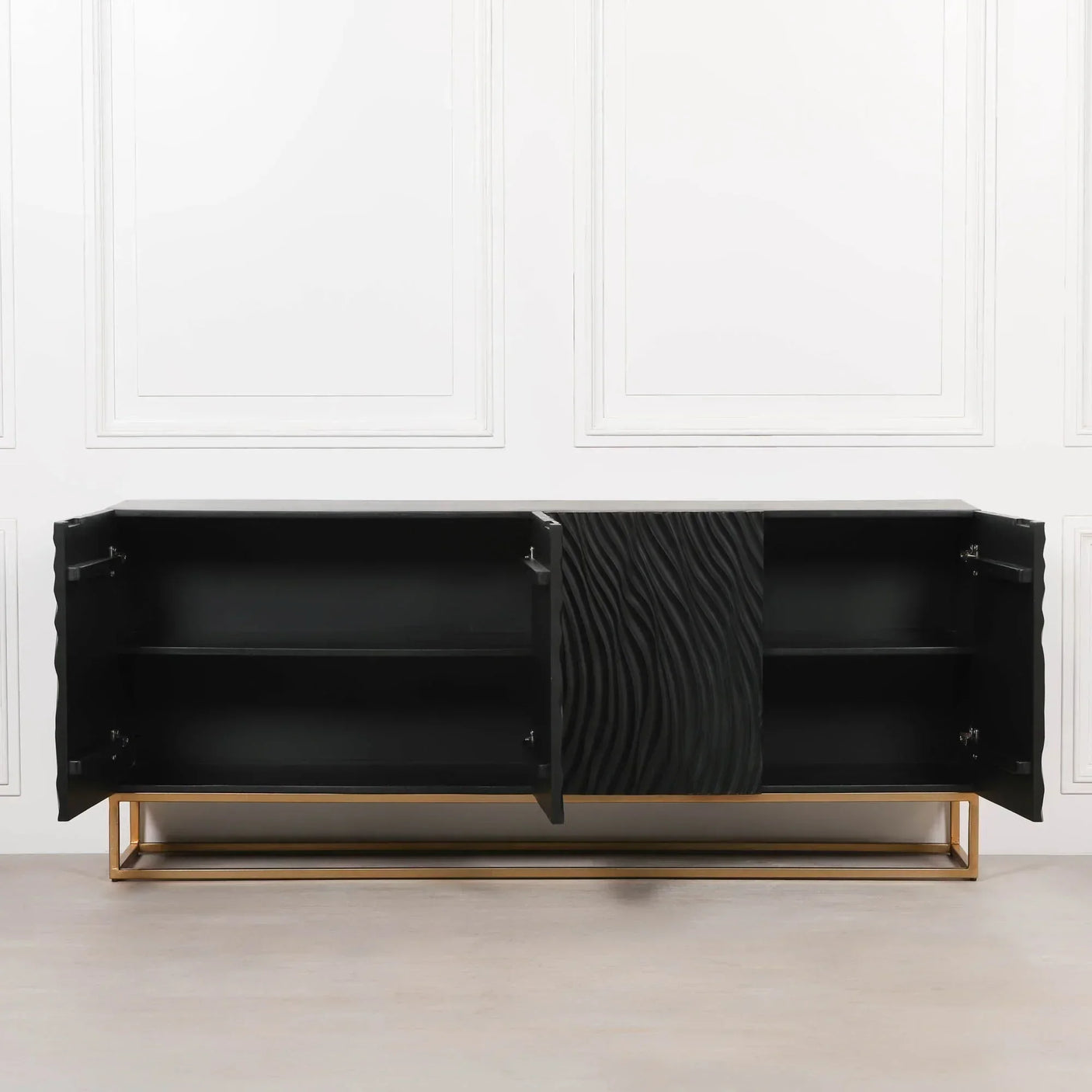 Black sideboard with textured doors, gold metal base, open shelving, viewed from front