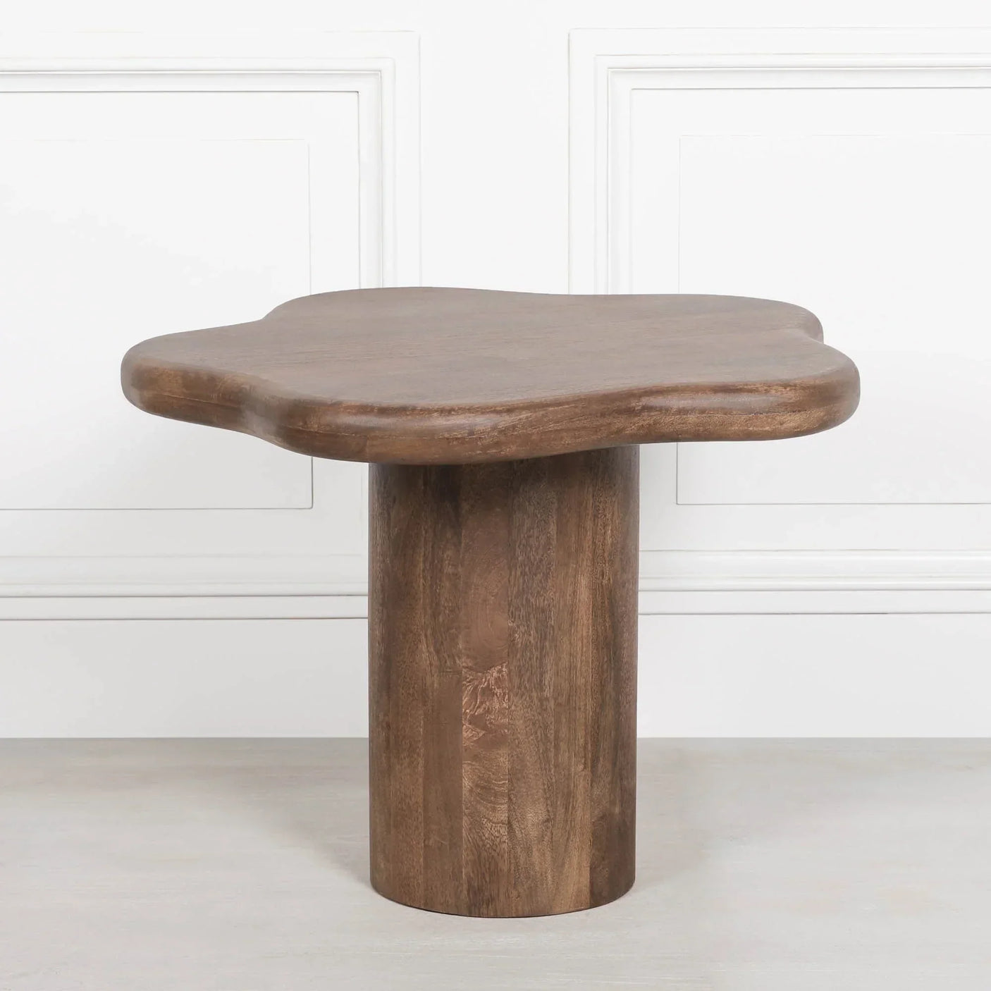 Solid wood coffee table with natural finish and irregular shaped top, modern pedestal base