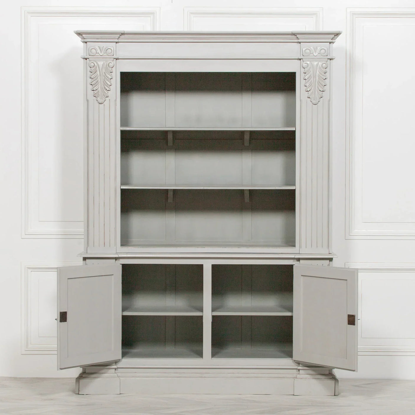 Grey wooden display cabinet with open lower doors and shelving, panelled detailing