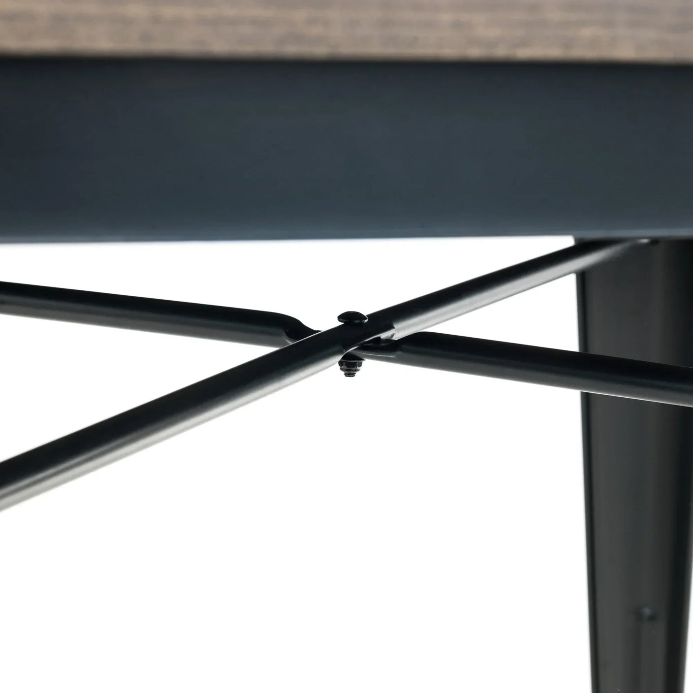 Dining table black metal cross frame detail under wooden tabletop