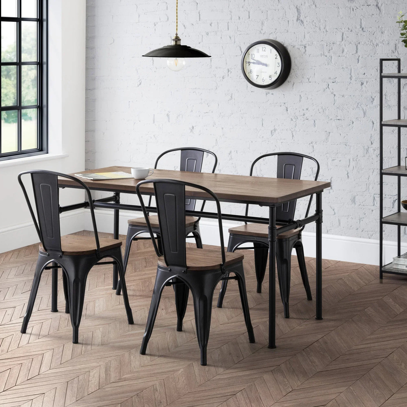 Industrial dining table set with four black metal and wood chairs in modern kitchen