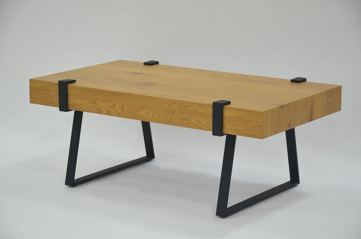 Oak coffee table with black metal legs and visible wood grain on white background