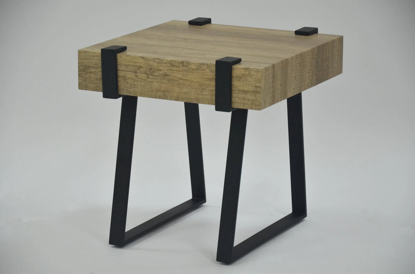 Rustic oak lamp table with thick wood top and black metal legs, angled side view