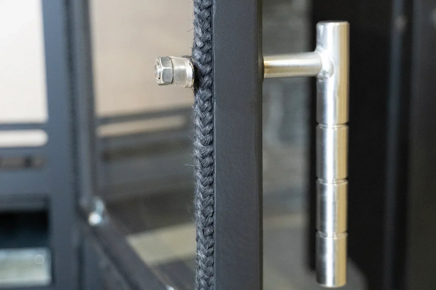 Close-up of Glenwood door hook on black metal frame with braided rope detailing