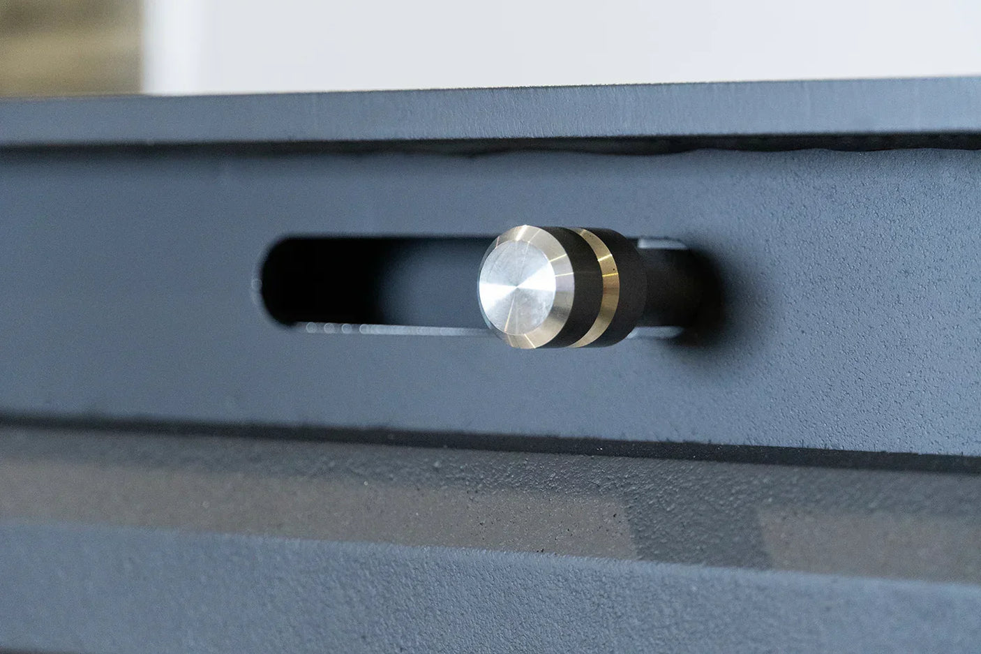 Close-up of Glenwood top-handle metal locking pin in matte black finish