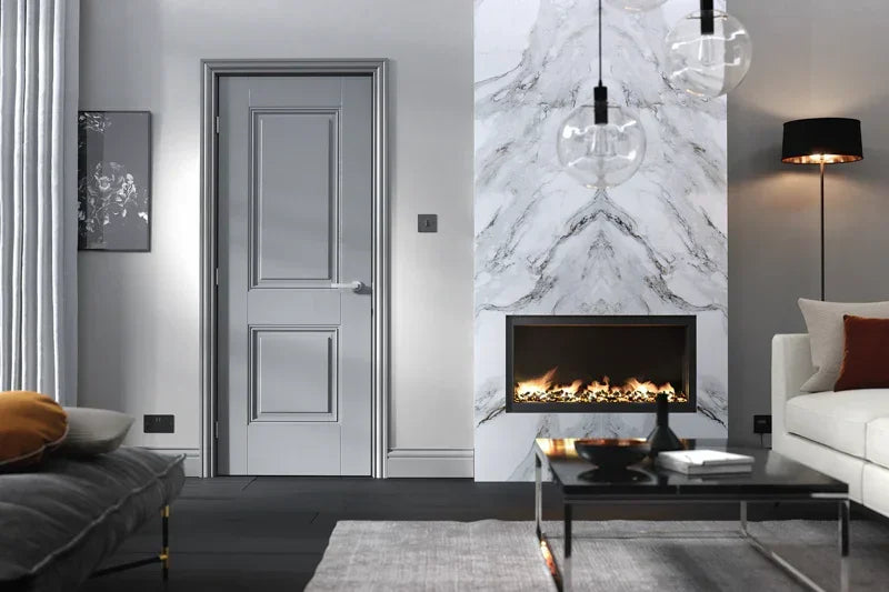 Grey wooden interior door with raised panels in modern living room with marble fireplace