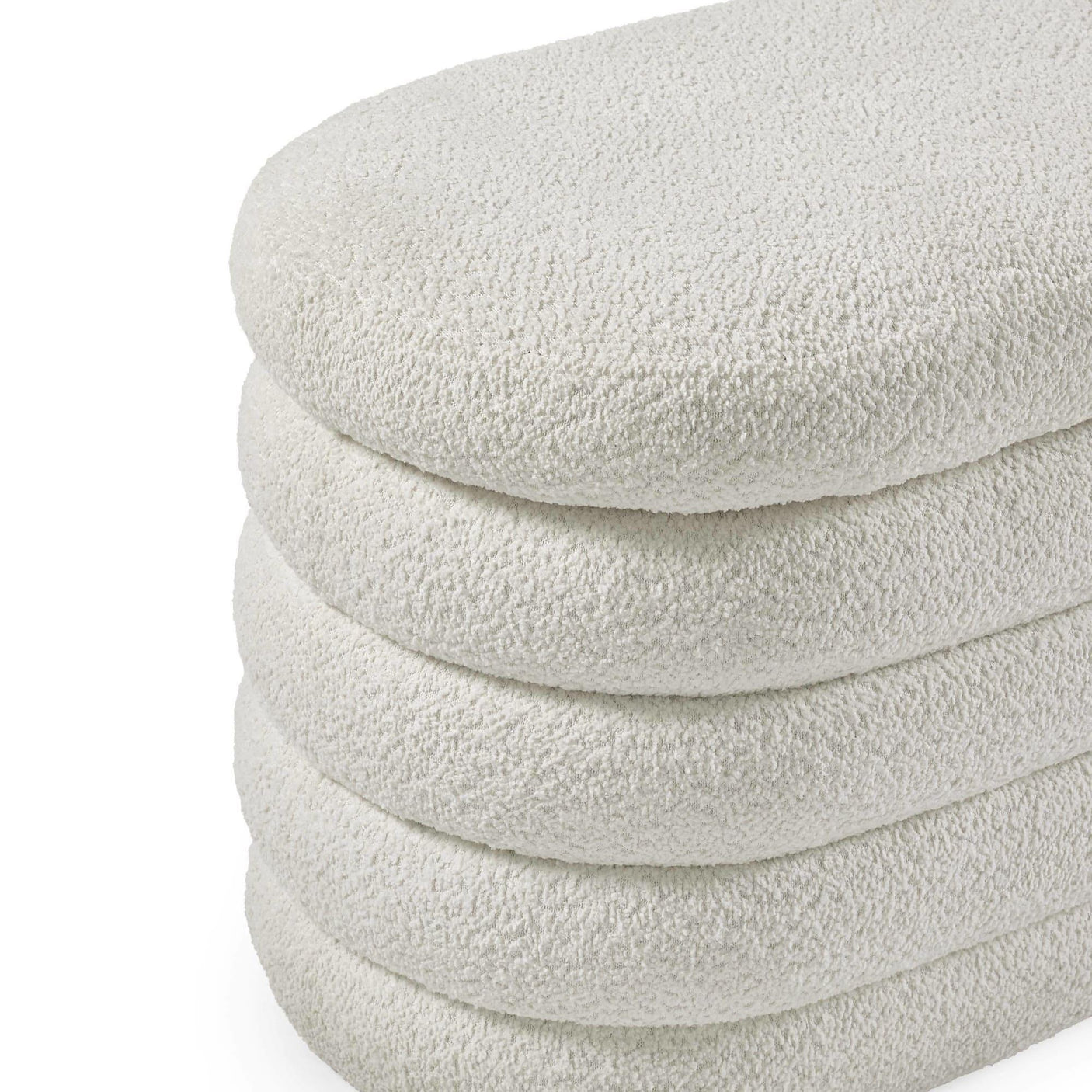 Close up of cream boucle ottoman with textured fabric and rounded stacked layers