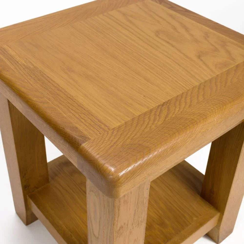 Oak lamp table with lower shelf and natural wood grain, angled corner view