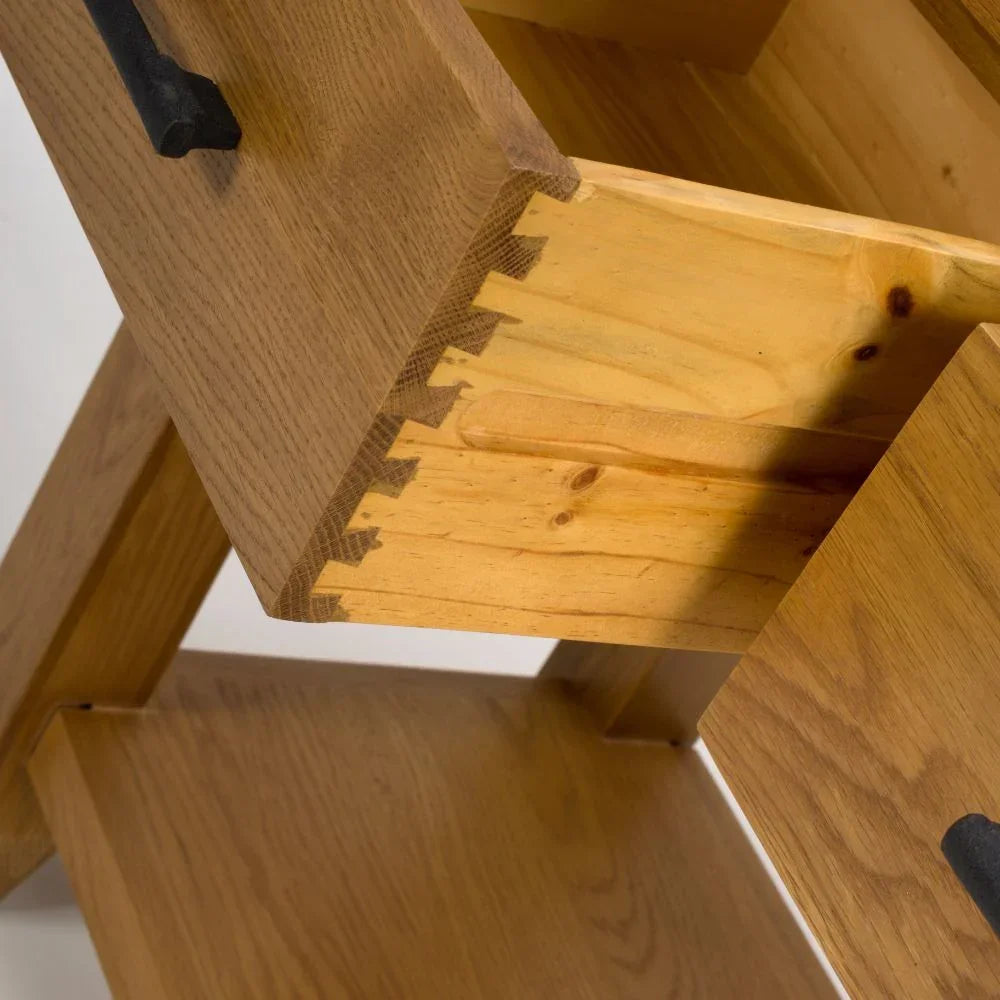 Solid oak furniture drawer with dovetail joints and black metal handle close-up
