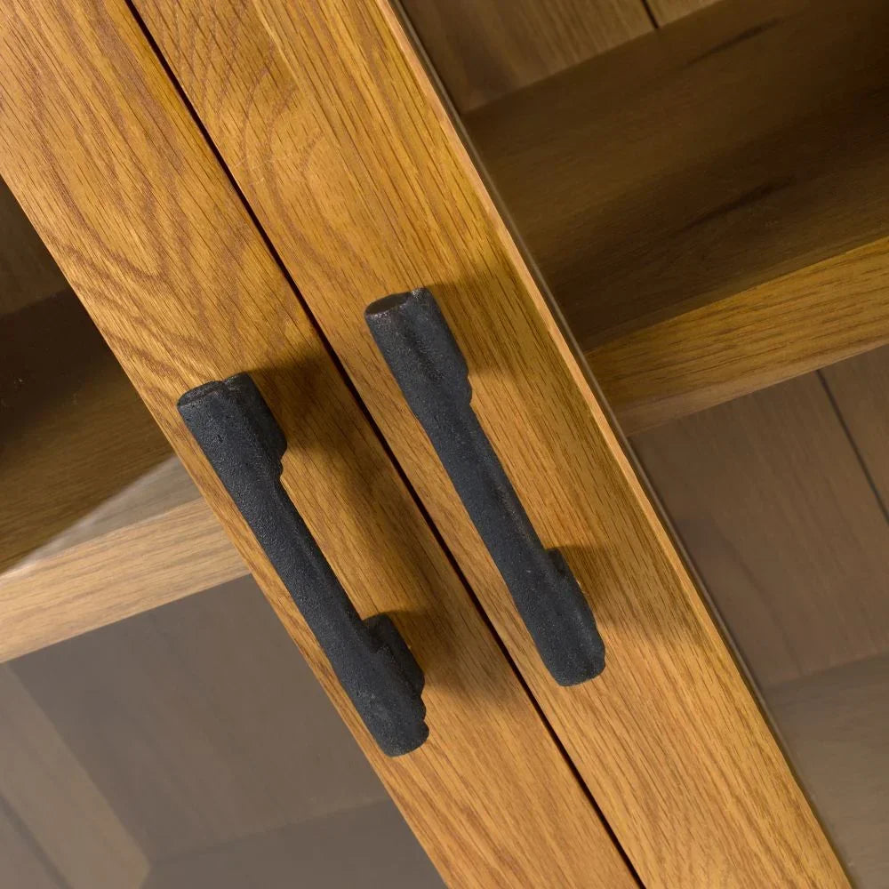 Oak cabinet doors with black metal handles and glass panels