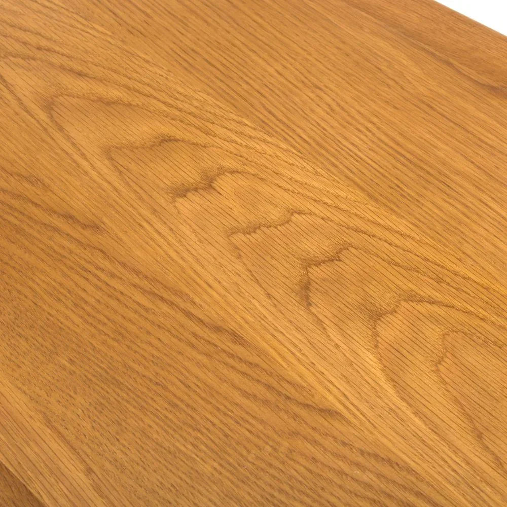 Closeup of oak dining table surface showing natural wood grain texture
