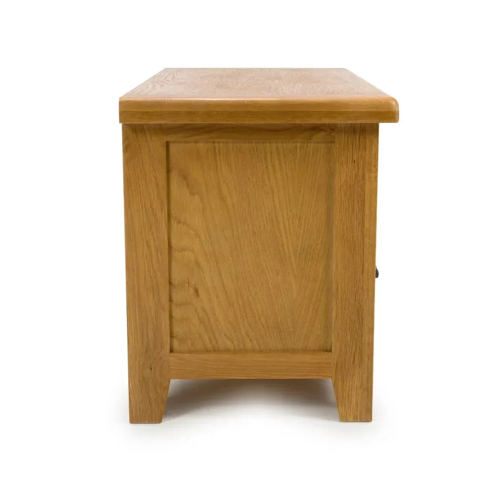 Oak side table with panelled end and natural wood grain, side view