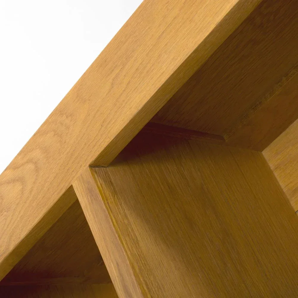 Close-up of oak bookcase shelf corner showing natural wood grain and joinery