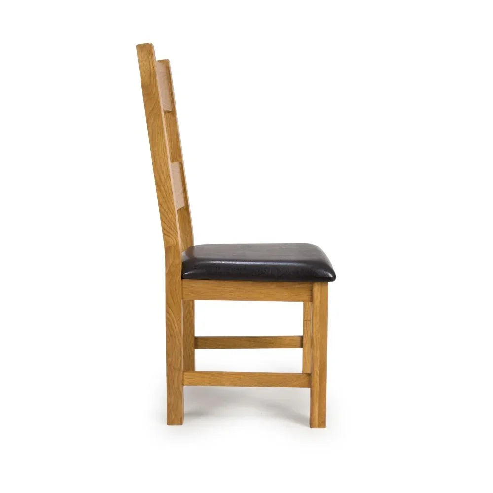 Oak dining chair with black cushioned seat, side view