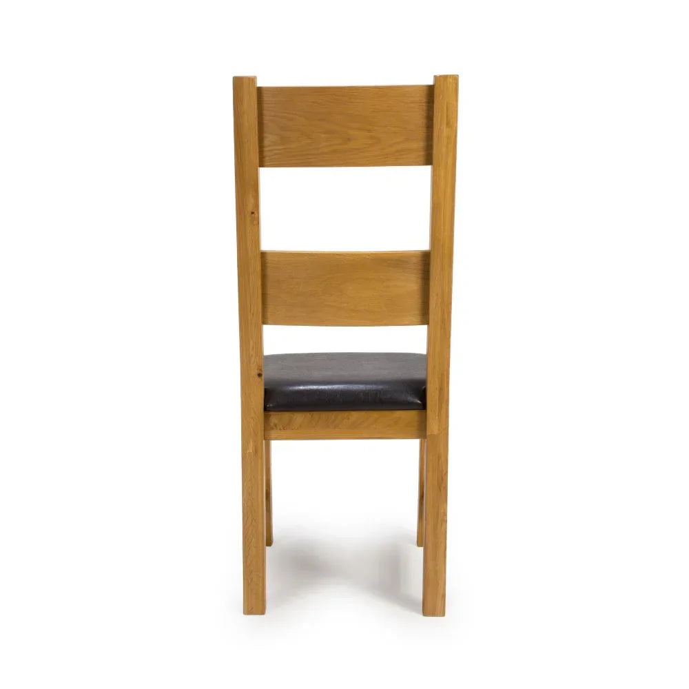 Oak dining chair with slatted back and black padded seat, rear view